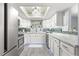 Modern kitchen featuring white cabinets, marble countertops, and a tin ceiling at 551 Fairways Dr # A, Ocala, FL 34472