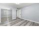 Bright bedroom with mirrored closet doors and wood-look floors at 551 Fairways Dr # A, Ocala, FL 34472