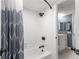 Clean bathroom with a shower/tub combo, gray walls, and white tile at 551 Fairways Dr # A, Ocala, FL 34472