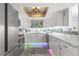 Modern kitchen features white cabinets, marble counters, and stylish backsplash at 551 Fairways Dr # A, Ocala, FL 34472