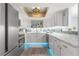 Modern kitchen featuring white cabinets, marble countertops, and a tin ceiling at 551 Fairways Dr # A, Ocala, FL 34472
