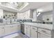 Modern white kitchen with marble countertops and a unique backsplash at 551 Fairways Dr # A, Ocala, FL 34472