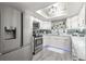 Modern white kitchen with stainless steel appliances and marble countertops at 551 Fairways Dr # A, Ocala, FL 34472