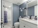 Updated bathroom with a white vanity, gray walls, and modern fixtures at 551 Fairways Dr # A, Ocala, FL 34472
