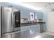 Bright kitchen with light blue cabinets, stainless steel appliances, and a tile backsplash at 8475 Se 137Th Loop, Summerfield, FL 34491