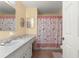 Well-maintained bathroom with shower/tub combo, single sink vanity, and tile flooring at 8475 Se 137Th Loop, Summerfield, FL 34491