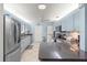Modern kitchen with stainless steel appliances and a breakfast bar at 8475 Se 137Th Loop, Summerfield, FL 34491