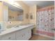 Clean bathroom with a shower/tub combo, vanity, and updated fixtures at 8475 Se 137Th Loop, Summerfield, FL 34491