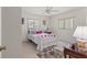 Bright bedroom with a double bed, carpet flooring, and window coverings at 8475 Se 137Th Loop, Summerfield, FL 34491