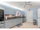 Updated kitchen featuring light blue cabinetry, stainless steel appliances, and tile flooring at 8475 Se 137Th Loop, Summerfield, FL 34491