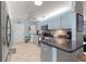 Clean kitchen with light blue cabinets, stainless steel appliances, and a granite countertop at 8475 Se 137Th Loop, Summerfield, FL 34491