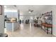 Open concept dining area with a wooden table and chairs, adjacent to kitchen at 8475 Se 137Th Loop, Summerfield, FL 34491