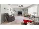 Relaxing living room featuring neutral walls, a ceiling fan, and comfortable furnishings at 8475 Se 137Th Loop, Summerfield, FL 34491