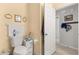 Guest bathroom with toilet, vanity, and additional storage at 8475 Se 137Th Loop, Summerfield, FL 34491