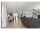 Bright living room with tile floors and a view into the dining area at 8475 Se 137Th Loop, Summerfield, FL 34491