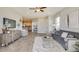 Living room with gray sofa, white rug, and views into the kitchen at 4737 Nw 39Th Street Rd, Ocala, FL 34482