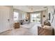 Living area with gray sofa, white rug and view into the dining and kitchen areas at 4737 Nw 39Th Street Rd, Ocala, FL 34482