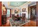Elegant formal dining room with chandelier, fireplace, and hardwood floors at 17800 Se 237Th Ct, Umatilla, FL 32784