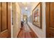 Elegant hallway with hardwood floors, built-in shelving, and framed artwork at 7819 Se 12Th Cir, Ocala, FL 34480