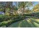 Private putting green surrounded by beautiful landscaping at 7819 Se 12Th Cir, Ocala, FL 34480