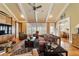 Open living room with hardwood floors, comfortable seating, and access to other rooms at 7819 Se 12Th Cir, Ocala, FL 34480