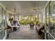 Spacious covered porch with wicker furniture and tranquil wooded views at 7819 Se 12Th Cir, Ocala, FL 34480