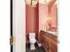 Powder room with decorative wallpaper and wood vanity at 7819 Se 12Th Cir, Ocala, FL 34480