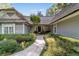Welcoming front entry with stone walkway and lush landscaping at 7819 Se 12Th Cir, Ocala, FL 34480