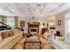 Spacious living room with hardwood floors, fireplace, and large windows at 7819 Se 12Th Cir, Ocala, FL 34480