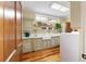 Bright laundry room with a large sink and cabinets at 7819 Se 12Th Cir, Ocala, FL 34480