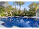 Inviting pool with spa and lounge area, surrounded by lush landscaping at 7819 Se 12Th Cir, Ocala, FL 34480