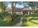 Gray home with a wrap-around porch and lush landscaping at 7819 Se 12Th Cir, Ocala, FL 34480