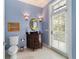 Elegant powder room with a mirrored vanity and access to the backyard at 7819 Se 12Th Cir, Ocala, FL 34480