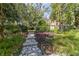 Landscaped pathway leading to a charming home nestled amongst lush greenery at 7819 Se 12Th Cir, Ocala, FL 34480