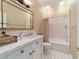 Clean bathroom with white tile and a bathtub at 7819 Se 12Th Cir, Ocala, FL 34480