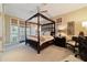 Spacious bedroom with a four-poster bed and access to a balcony at 7819 Se 12Th Cir, Ocala, FL 34480