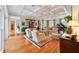 Spacious living room with hardwood floors, coffered ceiling, and large windows at 7819 Se 12Th Cir, Ocala, FL 34480