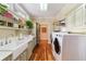 Laundry room with a farmhouse sink, washer, and dryer at 7819 Se 12Th Cir, Ocala, FL 34480