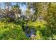 Serene pond surrounded by lush landscaping in the backyard at 7819 Se 12Th Cir, Ocala, FL 34480