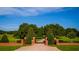 Grand estate entrance with brick pillars and wrought iron gates at 17800 Se 237Th Ct, Umatilla, FL 32784