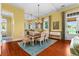Bright dining room features hardwood floors, chandelier, and access to the kitchen at 17800 Se 237Th Ct, Umatilla, FL 32784