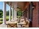 Elegant covered porch with seating area, brick columns, and tranquil view at 17800 Se 237Th Ct, Umatilla, FL 32784