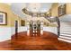 Two-story entryway with curved staircase and hardwood floors at 17800 Se 237Th Ct, Umatilla, FL 32784