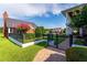 Landscaped backyard with gate and brick fence, showcasing a charming setting at 17800 Se 237Th Ct, Umatilla, FL 32784