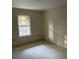 Empty bedroom with large window and neutral walls; new home construction at 13973 Se 35Th Ct, Summerfield, FL 34491