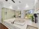 Relaxing bathroom with a large corner soaking tub and hardwood floors at 1218 Se 11Th St, Ocala, FL 34471
