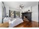 Bright bedroom with fireplace, hardwood floors, and ample natural light at 1218 Se 11Th St, Ocala, FL 34471