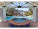 Brick hot tub with blue tile and covered patio at 1218 Se 11Th St, Ocala, FL 34471