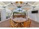 Covered patio with outdoor kitchen, dining area, and ceiling fan at 1218 Se 11Th St, Ocala, FL 34471