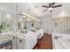 Bright bathroom boasts double vanity, large mirror, and soaking tub at 1218 Se 11Th St, Ocala, FL 34471